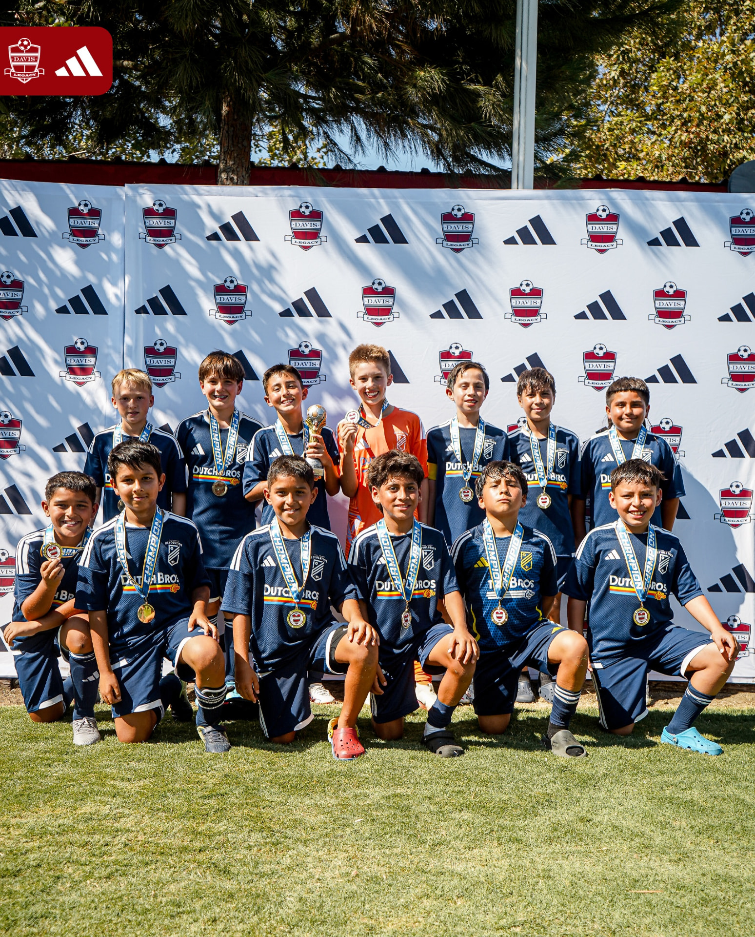 EC Revolution U11 Boys Blue champions with the Davis Legacy Super Clasico trophy and gold medals