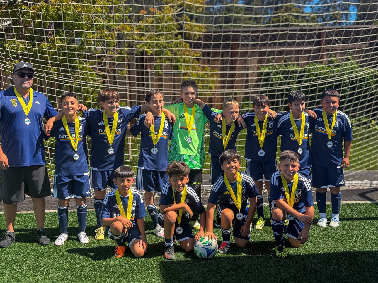 EC Revolution U11 Boys Blue with their Santa Cruz Breakers Summer Classic medals in front of the goal